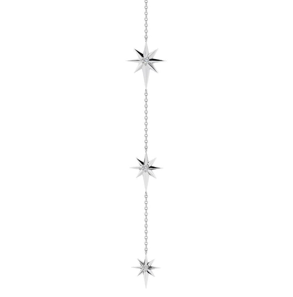 A silver Y-necklace featuring three vertical chains with three separate starburst pendants, shown against a plain white background.