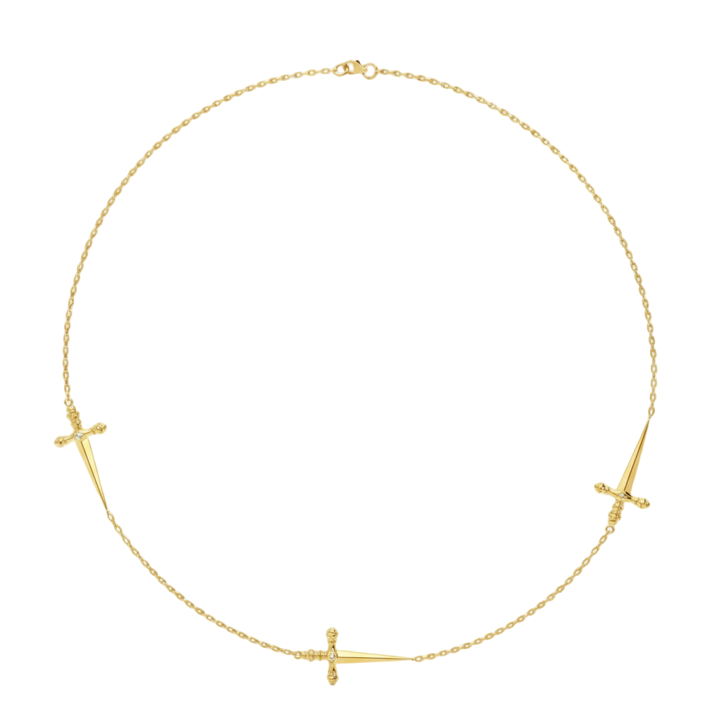 Gold necklace with three small sword pendants on a white background