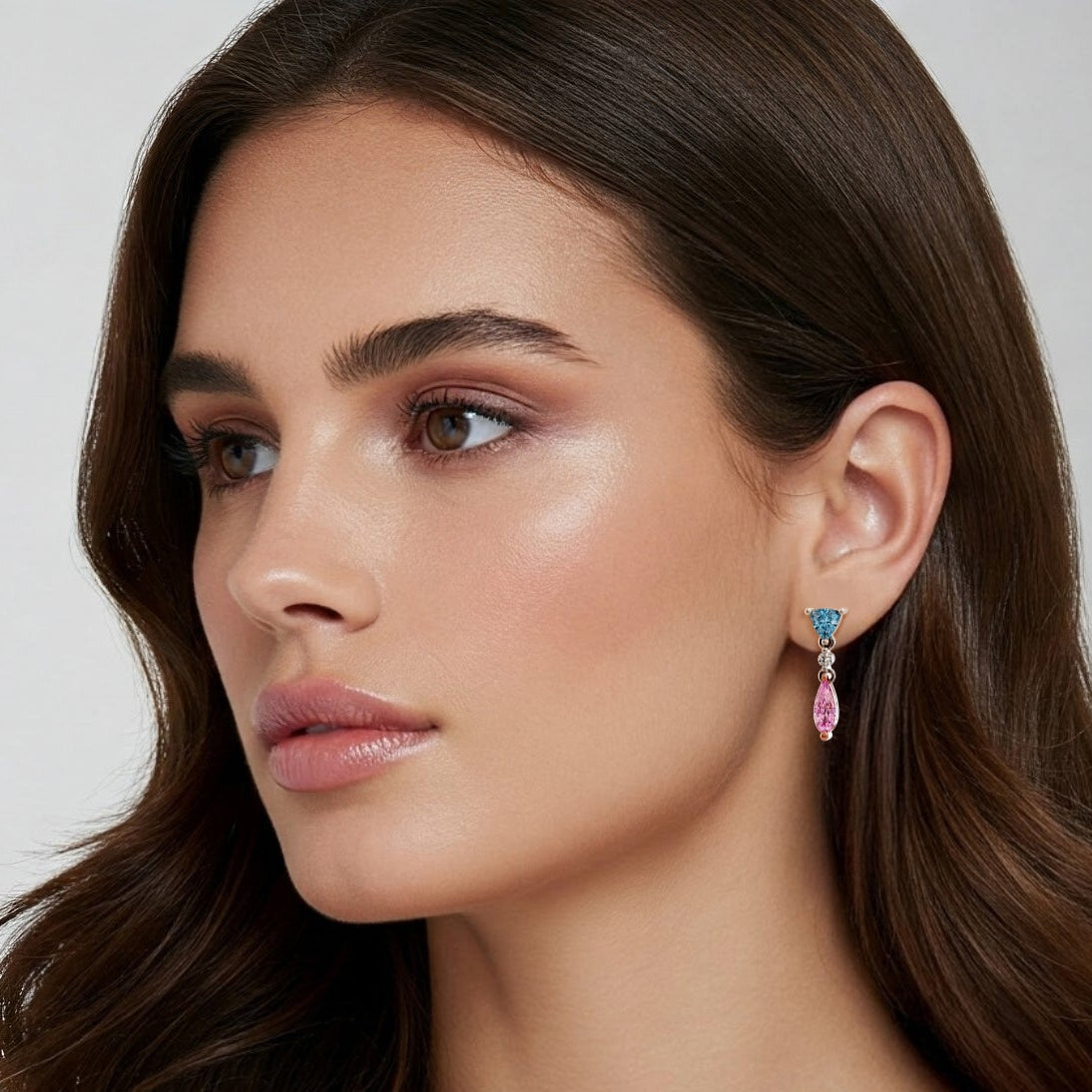 Woman wearing earrings with a neutral background